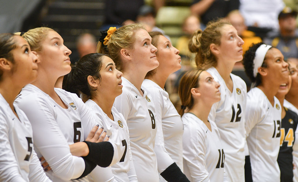Missouri volleyball players look up at the scoreboard
